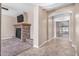 Open-concept living room with a stone fireplace, tile flooring, and neutral paint at 17192 W Post Dr, Surprise, AZ 85388