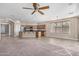 Open-concept living space with carpet seamlessly connected to a kitchen with tile flooring at 17192 W Post Dr, Surprise, AZ 85388