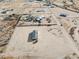 Aerial view of a desert neighborhood featuring multiple manufactured homes and expansive lots at 1811 N Brower Ln, Maricopa, AZ 85139