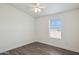 Clean bedroom featuring wood look floors, a modern ceiling fan and a large window at 1811 N Brower Ln, Maricopa, AZ 85139