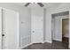 A well-lit hallway with gray walls, modern flooring, white doors and a functional ventilation system at 1811 N Brower Ln, Maricopa, AZ 85139