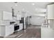 Bright, modern kitchen featuring stainless steel appliances, white cabinetry and light countertops at 1811 N Brower Ln, Maricopa, AZ 85139