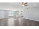 Spacious living room flows into the kitchen, featuring lots of windows, recessed lights, and modern flooring at 1811 N Brower Ln, Maricopa, AZ 85139