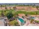 Aerial view showcases a backyard pool and golf course at 1831 W San Angelo St, Gilbert, AZ 85233