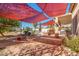 Expansive backyard with custom brickwork, lush greenery, and multiple seating areas provides ample space for outdoor living at 1831 W San Angelo St, Gilbert, AZ 85233