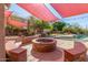 Beautifully landscaped backyard featuring a cozy firepit surrounded by seating, ideal for gathering with friends and Gathering at 1831 W San Angelo St, Gilbert, AZ 85233