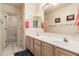 Bright bathroom featuring double sinks, neutral walls, and a vanity mirror at 1831 W San Angelo St, Gilbert, AZ 85233