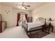 Bedroom featuring a metal bed frame, carpet, and an exit leading to a balcony at 1831 W San Angelo St, Gilbert, AZ 85233