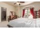 Bedroom with carpet, metal frame bed, dresser, and window with bright red curtains at 1831 W San Angelo St, Gilbert, AZ 85233