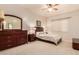 Cozy bedroom with soft carpet, warm lighting, and classic furniture at 1831 W San Angelo St, Gilbert, AZ 85233