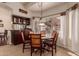 Cozy dining area with warm wood accents, a hanging light fixture, and large windows bringing in natural light at 1831 W San Angelo St, Gilbert, AZ 85233