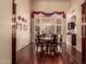 Elegant dining room showcasing hardwood floors, a large window, and a classic chandelier providing an elegant space at 1831 W San Angelo St, Gilbert, AZ 85233