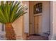 Inviting front entrance with a wood door, stylish light fixture, and desert-friendly landscaping at 1831 W San Angelo St, Gilbert, AZ 85233