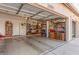 Spacious garage featuring a storage, an open door, and concrete flooring at 1831 W San Angelo St, Gilbert, AZ 85233