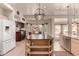 This light and bright kitchen features an island with marble countertops and stainless steel appliances at 1831 W San Angelo St, Gilbert, AZ 85233