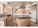 Bright, functional kitchen featuring stainless steel appliances, a central island, and ample counter space, perfect for culinary enthusiasts at 1831 W San Angelo St, Gilbert, AZ 85233