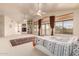 Expansive main bedroom features a fireplace, built-in shelving, and a large window at 1831 W San Angelo St, Gilbert, AZ 85233