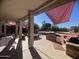 Covered patio featuring an outdoor kitchen, built-in grill, and shade sails for comfortable outdoor living at 1831 W San Angelo St, Gilbert, AZ 85233