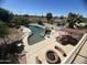 Aerial view of the backyard oasis with a large pool, spa, outdoor kitchen, and golf course views at 1831 W San Angelo St, Gilbert, AZ 85233