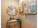 Bathroom vanity with round mirror, granite countertop, and decorative wall art, combining style and functionality at 23415 S 202Nd St, Queen Creek, AZ 85142