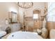 Bathroom showcasing an elegant bathtub, walk-in shower, granite vanity, and decorative light fixtures at 23415 S 202Nd St, Queen Creek, AZ 85142