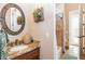 Bathroom featuring a granite countertop, decorative mirror, and a tiled shower/tub combination, offering a functional space at 23415 S 202Nd St, Queen Creek, AZ 85142