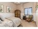 A bedroom featuring a window, chair, and armoire at 23415 S 202Nd St, Queen Creek, AZ 85142