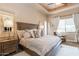 Spacious main bedroom features a tray ceiling, designer bedding, and a cozy sitting area at 23415 S 202Nd St, Queen Creek, AZ 85142