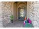 Covered entryway with decorative wrought iron door and stone accents at 23415 S 202Nd St, Queen Creek, AZ 85142