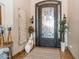 Grand entrance with ornate iron door, decorative vases, and sconce lighting at 23415 S 202Nd St, Queen Creek, AZ 85142