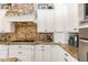 Close up of kitchen features stone backsplash, granite counter tops and stainless appliances at 23415 S 202Nd St, Queen Creek, AZ 85142