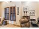 Home office with custom shutters and a built-in shelving unit with decorative display items at 23415 S 202Nd St, Queen Creek, AZ 85142