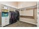 A walk-in closet featuring custom shelving and multiple storage options at 23415 S 202Nd St, Queen Creek, AZ 85142