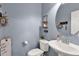 Neat half bathroom with modern fixtures, decorative mirror, and stylish wall decor at 2463 E Stacey Rd, Gilbert, AZ 85298