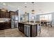 Kitchen island with stainless dishwasher, granite countertops, seating and views of the dining area at 2463 E Stacey Rd, Gilbert, AZ 85298