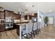 Bright kitchen featuring wood-look floors, stainless steel appliances, and a center island with seating at 2463 E Stacey Rd, Gilbert, AZ 85298