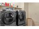 A modern laundry room featuring high-end, front-load washer and dryer at 2463 E Stacey Rd, Gilbert, AZ 85298