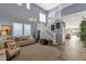 Spacious living room featuring high ceilings, stylish decor, and a staircase leading to the upper level at 2463 E Stacey Rd, Gilbert, AZ 85298