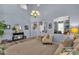 Bright and airy living room featuring comfortable seating, a decorative console table, and an open floor plan at 2463 E Stacey Rd, Gilbert, AZ 85298