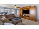 Comfortable living room featuring a large entertainment center with sliding barn doors at 2463 E Stacey Rd, Gilbert, AZ 85298