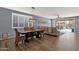 Open concept dining/living area with wood-look tile, shutters, and a view to the backyard at 2463 E Stacey Rd, Gilbert, AZ 85298