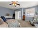 Serene main bedroom featuring carpet, a ceiling fan, and a comfy chair and doors to other rooms at 2463 E Stacey Rd, Gilbert, AZ 85298