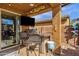 Covered patio with a grill, outdoor seating, and view of the backyard at 2463 E Stacey Rd, Gilbert, AZ 85298