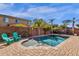 Backyard swimming pool with mature landscaping, lounge chairs, and clear blue sky at 2463 E Stacey Rd, Gilbert, AZ 85298