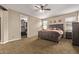 Bedroom featuring a ceiling fan, a large window, a walk-in closet and carpeted floors at 25907 N 134Th Dr, Peoria, AZ 85383