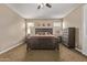 Bedroom featuring a ceiling fan, a large window and carpeted floors at 25907 N 134Th Dr, Peoria, AZ 85383