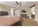 Bedroom featuring a ceiling fan, carpeted floors, a TV and a closet with white doors at 25907 N 134Th Dr, Peoria, AZ 85383