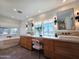 Bright bathroom with double sinks, vanity space, large windows, freestanding tub, and modern light fixtures at 2946 E Flower St, Phoenix, AZ 85016