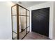 Modern bathroom features a glass shower, herringbone tile flooring, and a unique black sliding door at 2946 E Flower St, Phoenix, AZ 85016