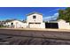 View of the garage and house with a white garage door and black trim at 2946 E Flower St, Phoenix, AZ 85016